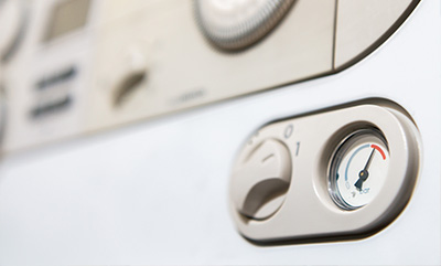 control panel with pressure gauge indicating levels and dial settings for precise operation numeral 2 for adjustments