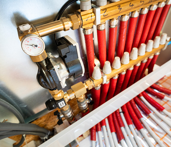 pipeline system with multiple red tubes and a pressure gauge featuring twelve connections