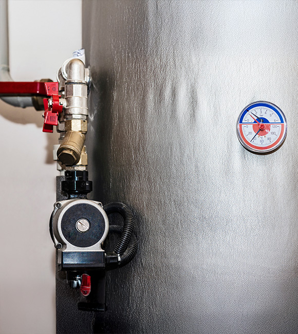 metallic water heater with pressure gauge and pump attached operating at eleven degrees Celsius